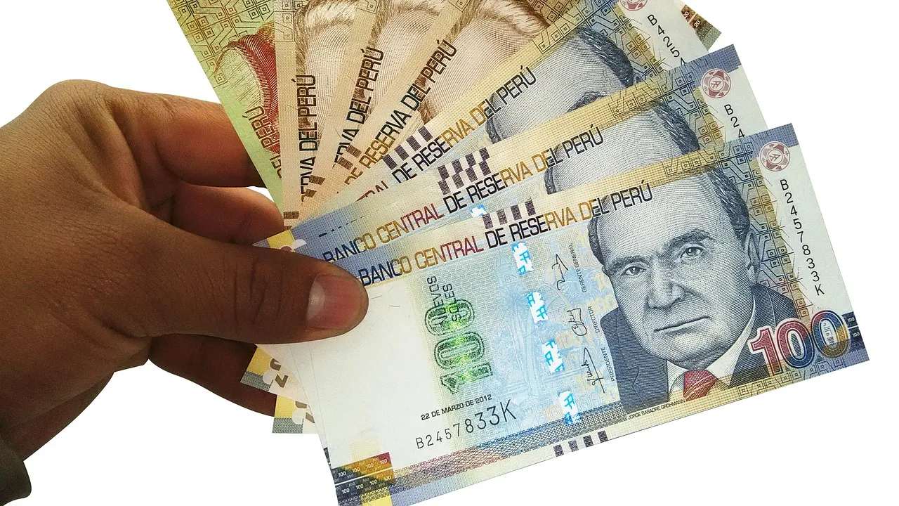 Money and banknotes arranged on a surface
