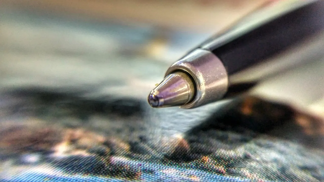 A close-up of a pen resting on paperwork