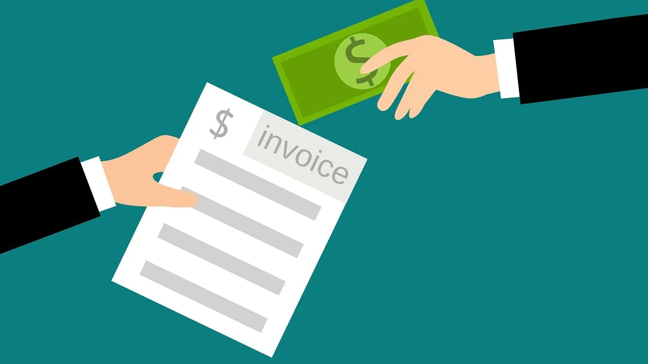 An invoice document with cash on a desk
