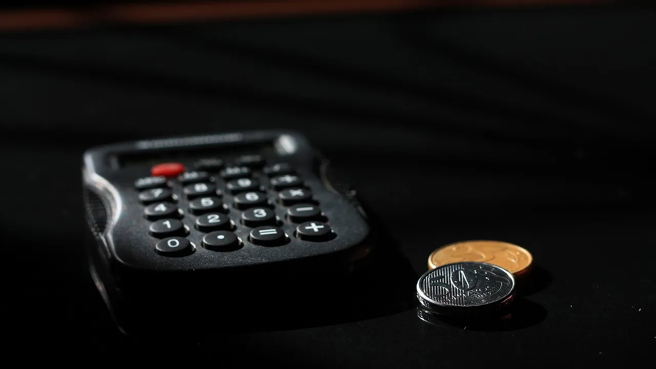A tidy desk with accounting papers and a calculator